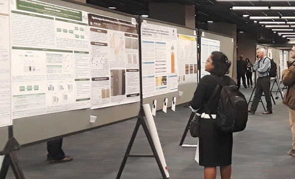 female scientist reviewing a next-generation sequencing poster at ASM NGS