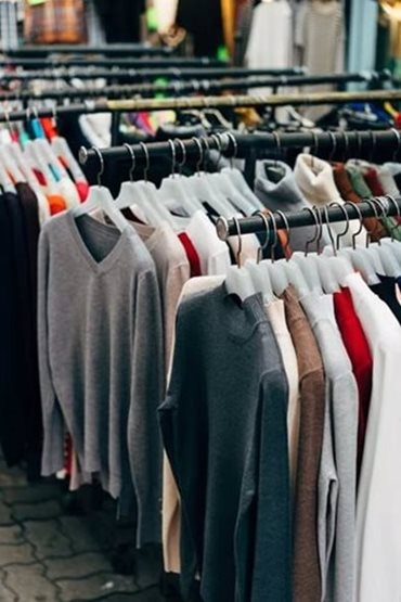 Shirts hanging on a clothing rack.