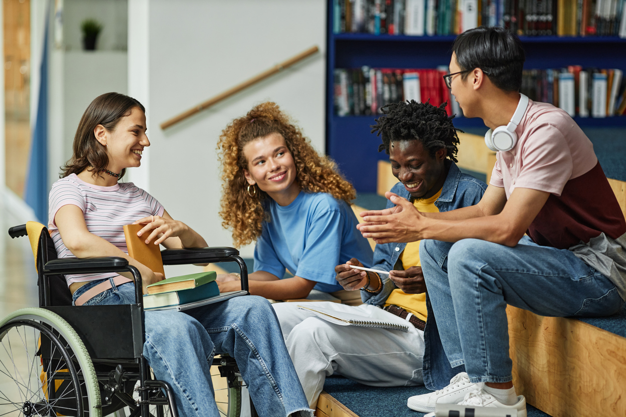 Students gather to talk in a library.