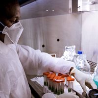 A lab tech in Mozambique applies new skills acquired from ASM training.