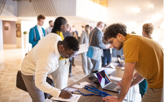 Participants registering for a conference.