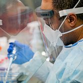 A clinical lab worker tests various samples.