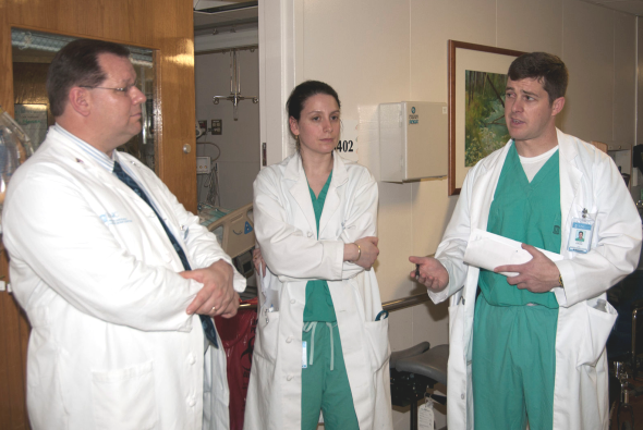 Three clinical microbiologists in discussion.